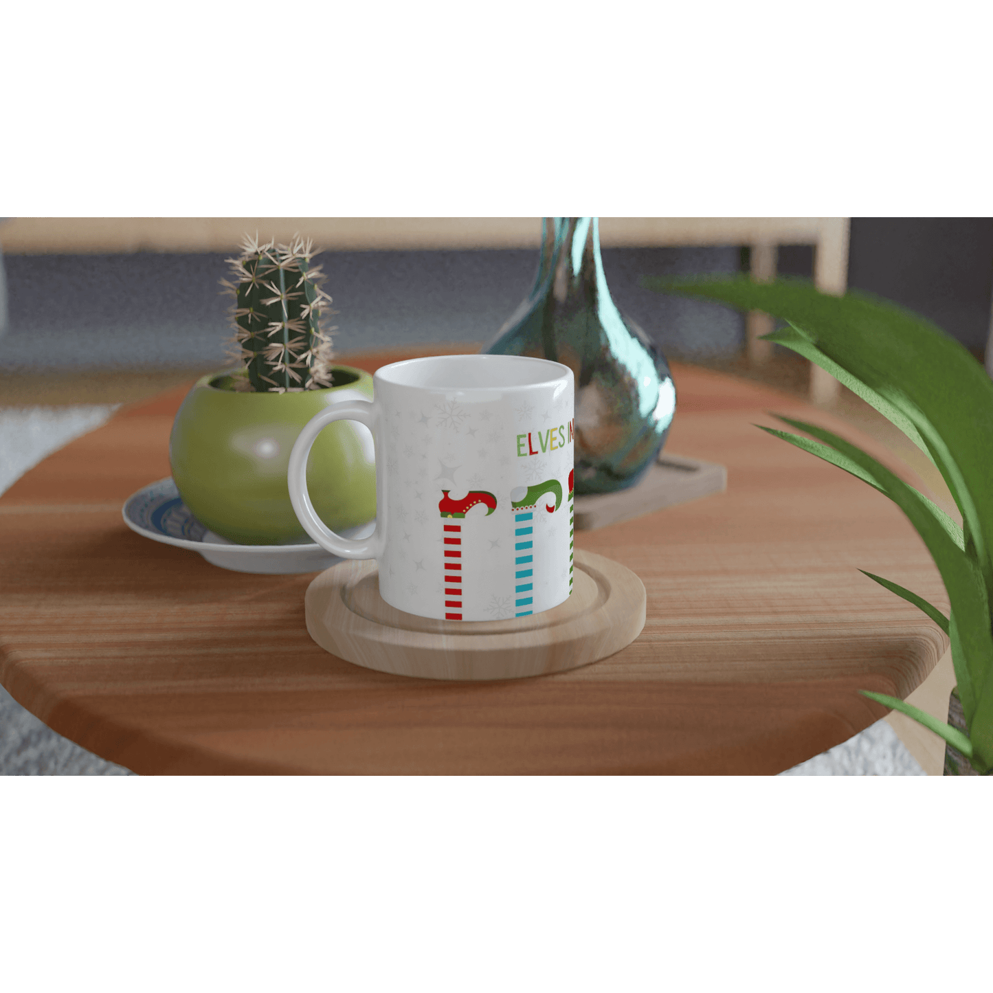 White mug with colorful designs of 'elves in training' .
