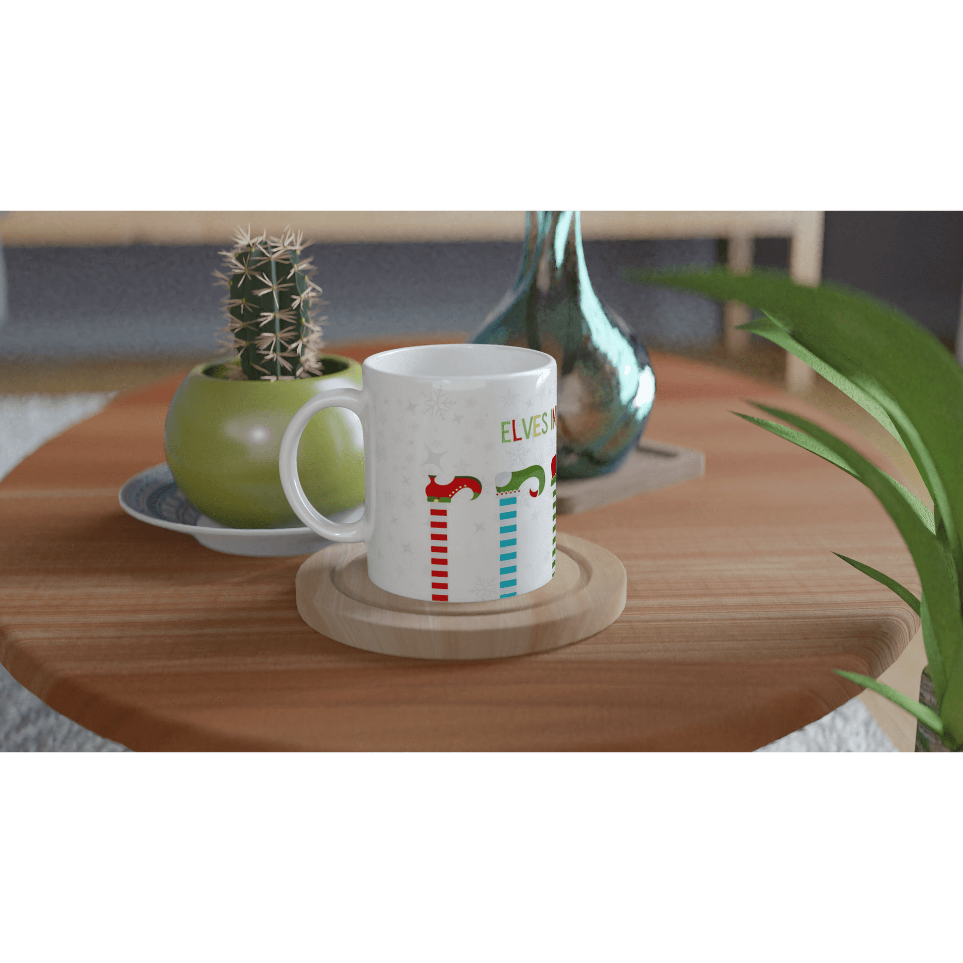 White mug with colorful designs of 'elves in training' .