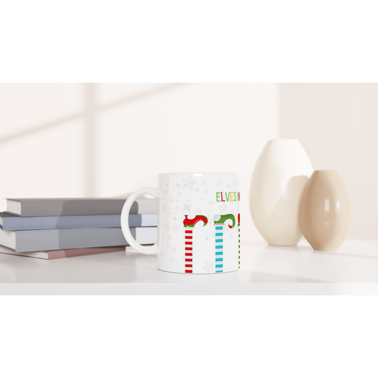 Mug with colorful designs and text 'Elves in training'.