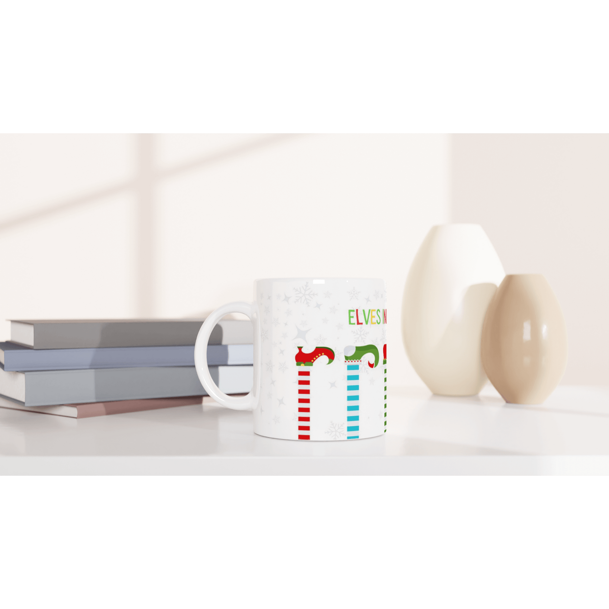 Mug with colorful designs and text 'Elves in training'.