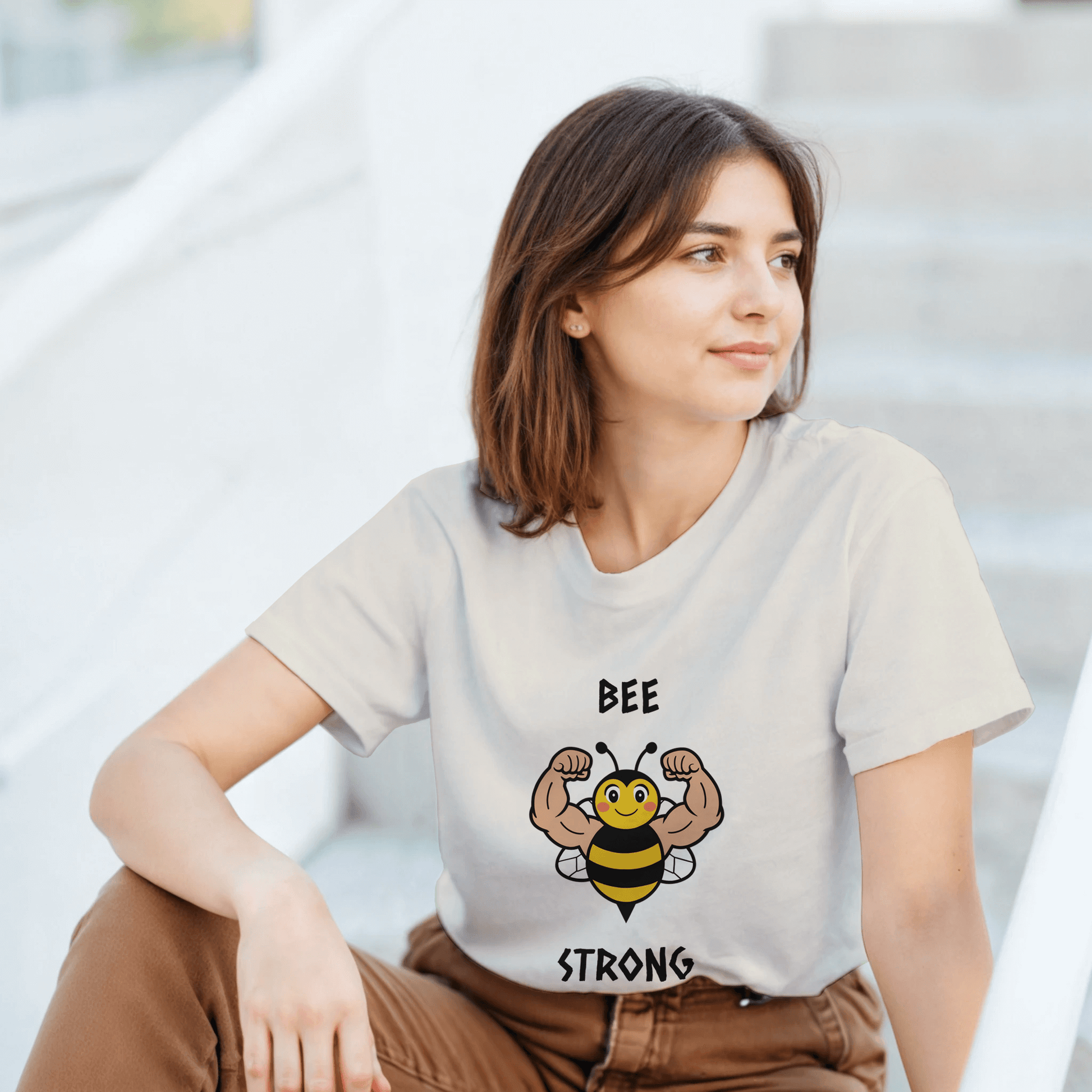 a t-shirt with a bee graphic and 'BEE STRONG' text.