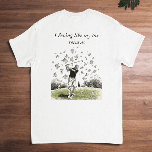 White t-shirt with a graphic of a golfer and text 'I Swing like my tax returns'