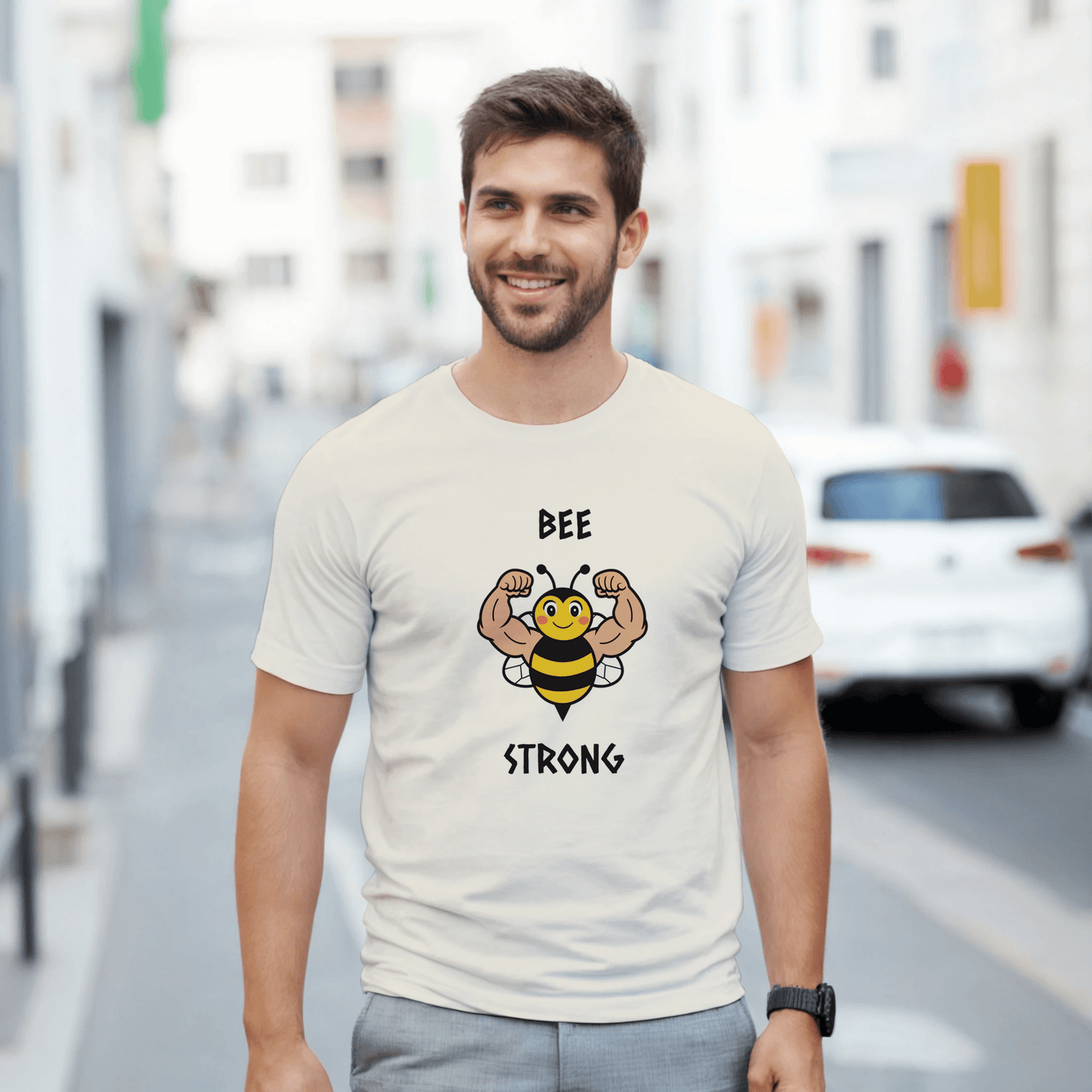 a white t-shirt with a bee graphic and 'BEE STRONG' text