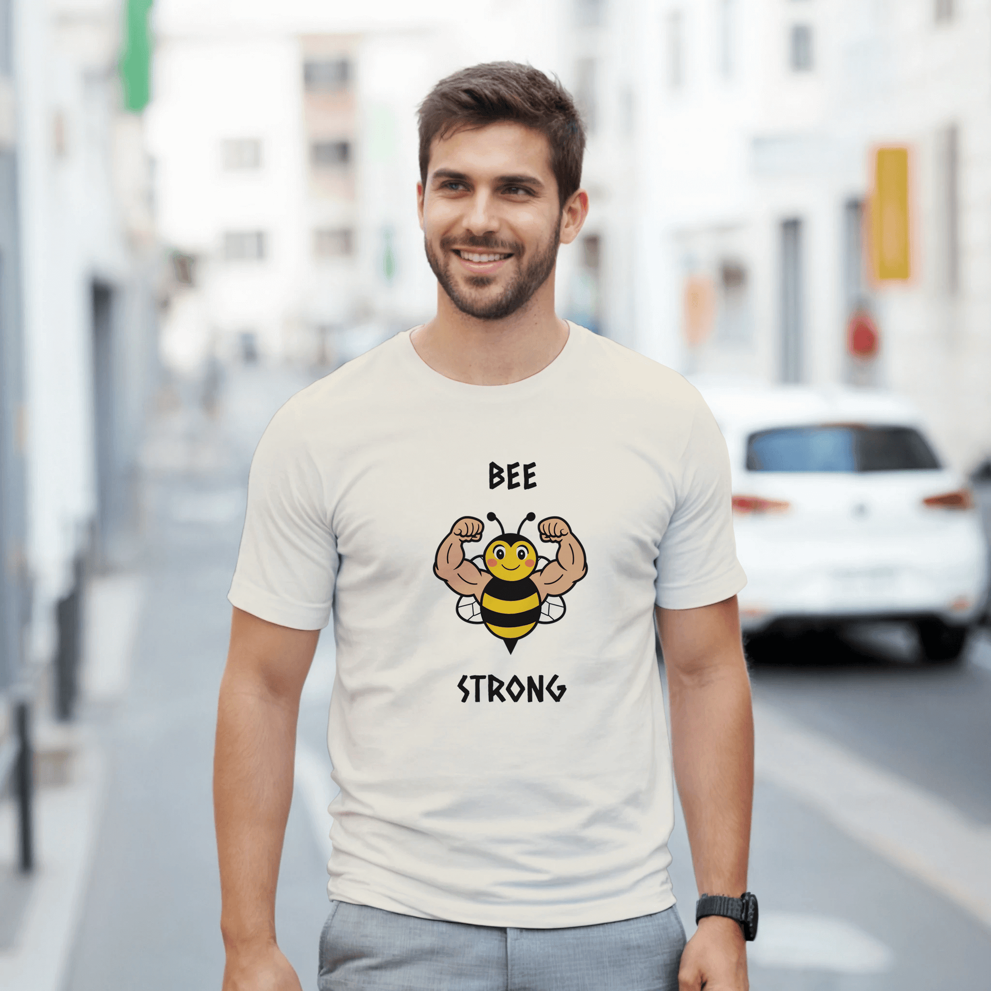 a white t-shirt with a bee graphic and 'BEE STRONG' text