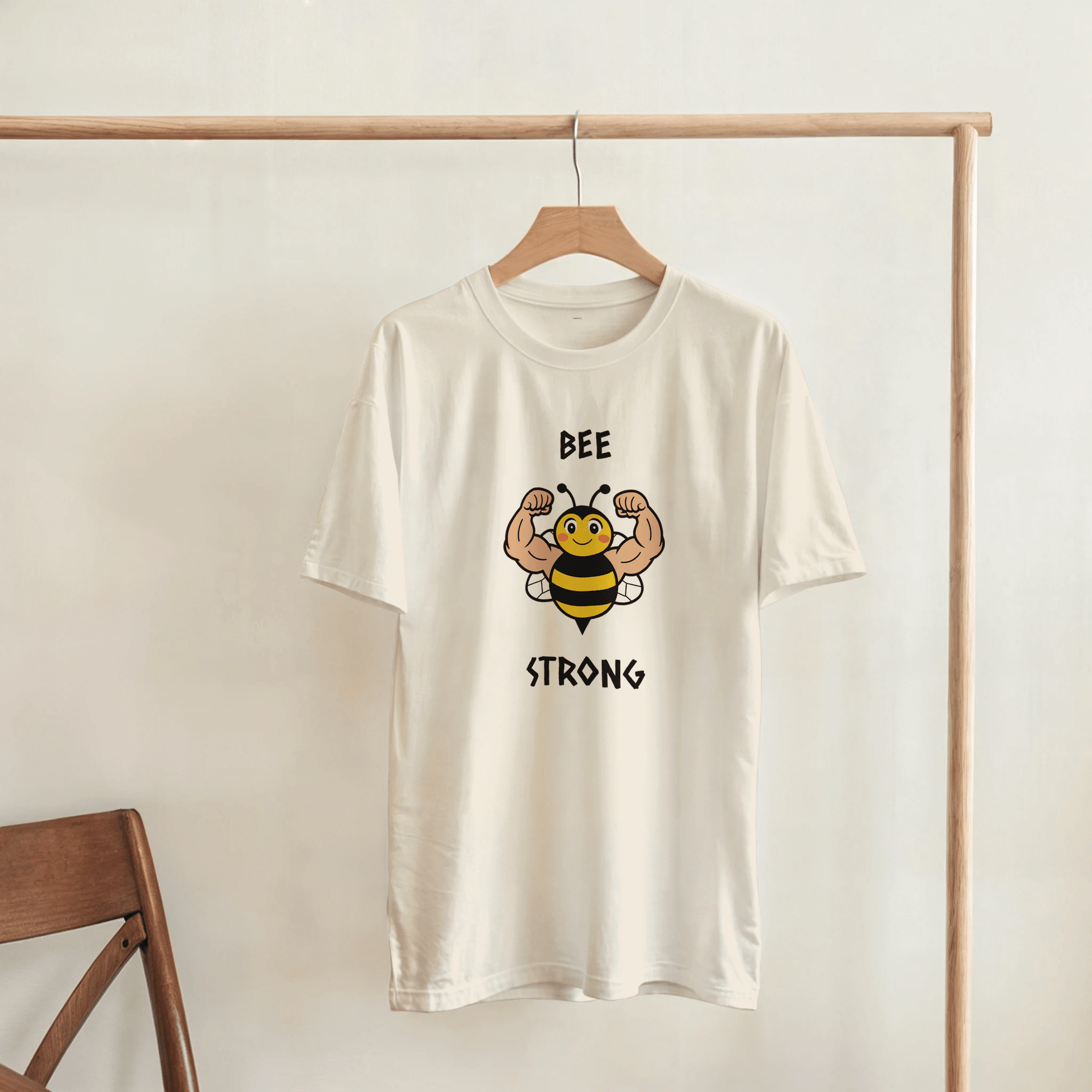 White t-shirt with a bee graphic and 'BEE STRONG' text