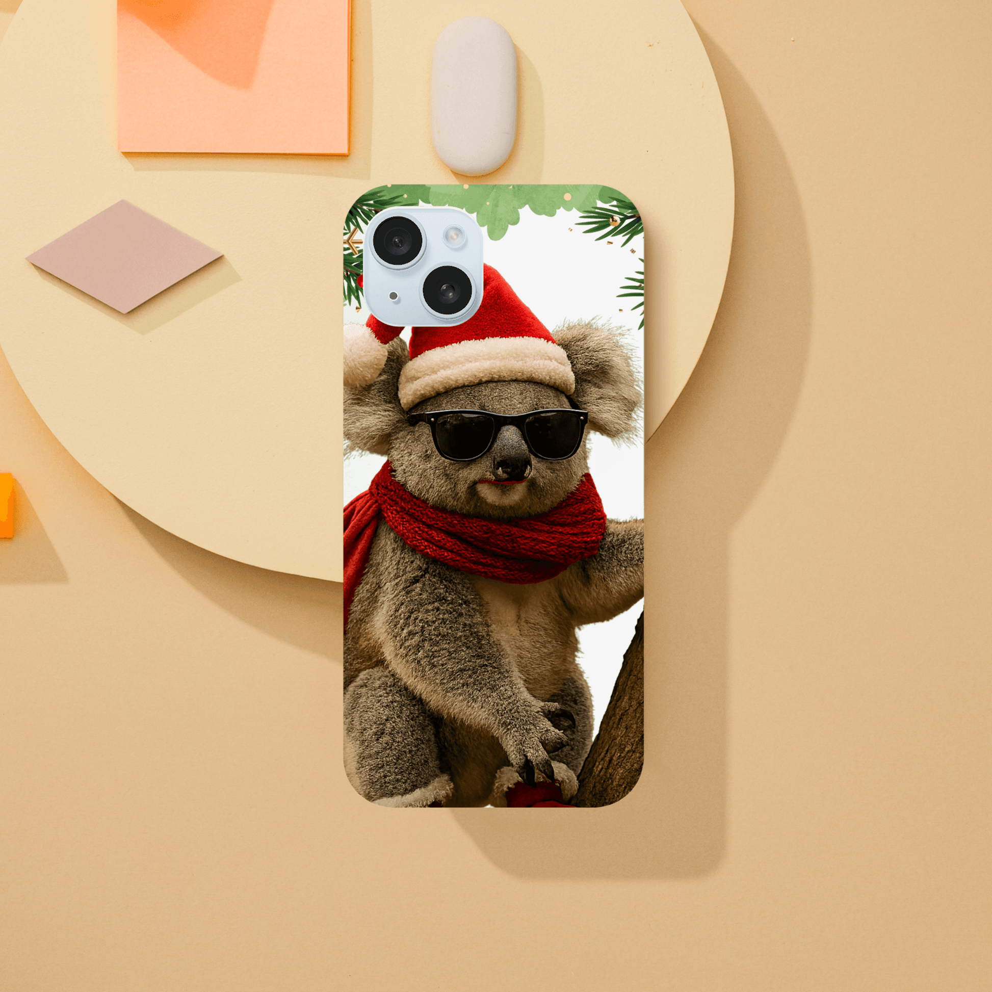 Phone case with a design of a koala wearing sunglasses and a Santa hat 