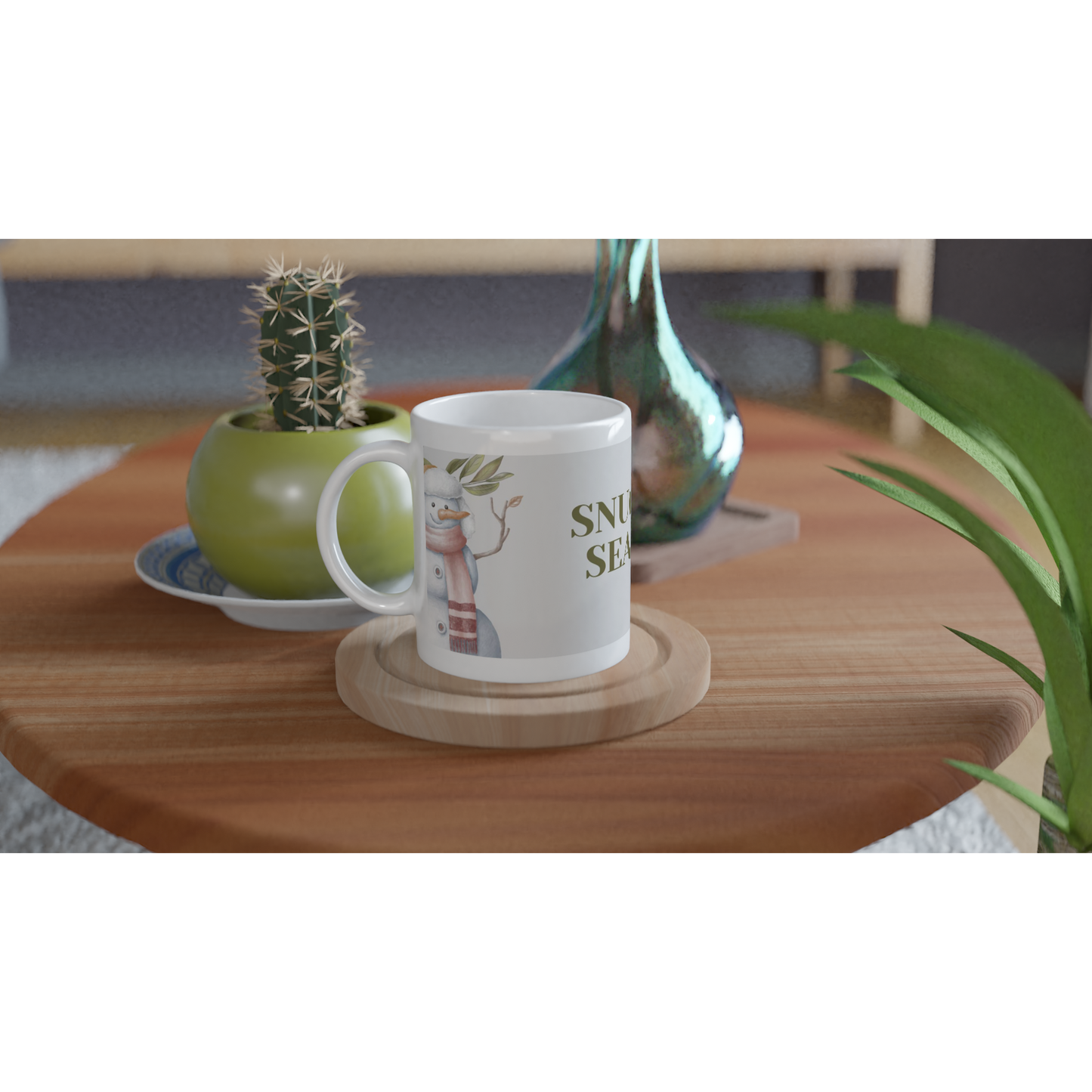 White mug with a design of a snowman and text 'snuggle season' on it.